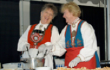 Margaret Schwalm and Hazel Clegg have a blast at Norway Days<br /> in San Francisco demonstrating their Norwegian culinary skills aasewomen.png